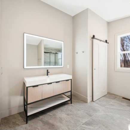 Bathroom vanity with backlit mirror and sliding barn door