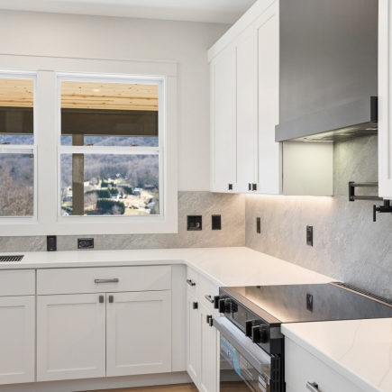 Kitchen corner with mountain-view window above the countertop