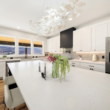 Kitchen island with floral arrangement and mountain-view windows