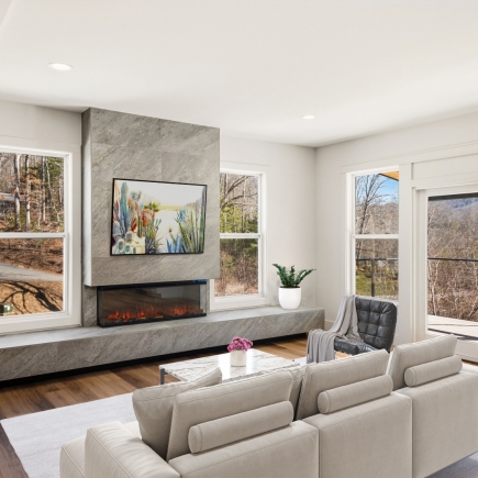 Living room with linear fireplace, stone surround, and sectional sofa