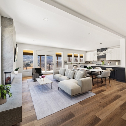 Open-concept living, dining, and kitchen area with panoramic mountain-view windows